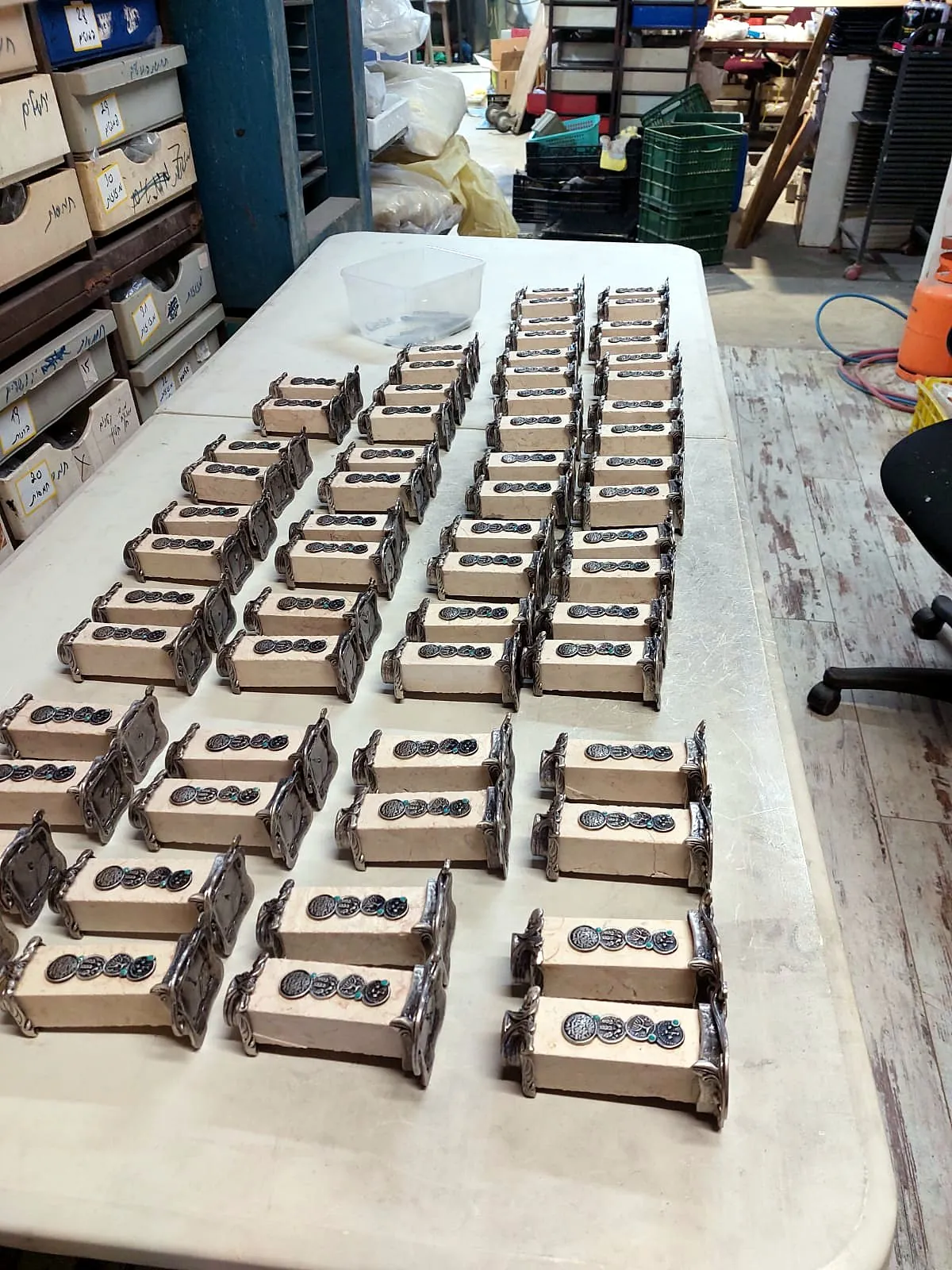 Rows of finished biblical coin and Jerusalem stone gifts