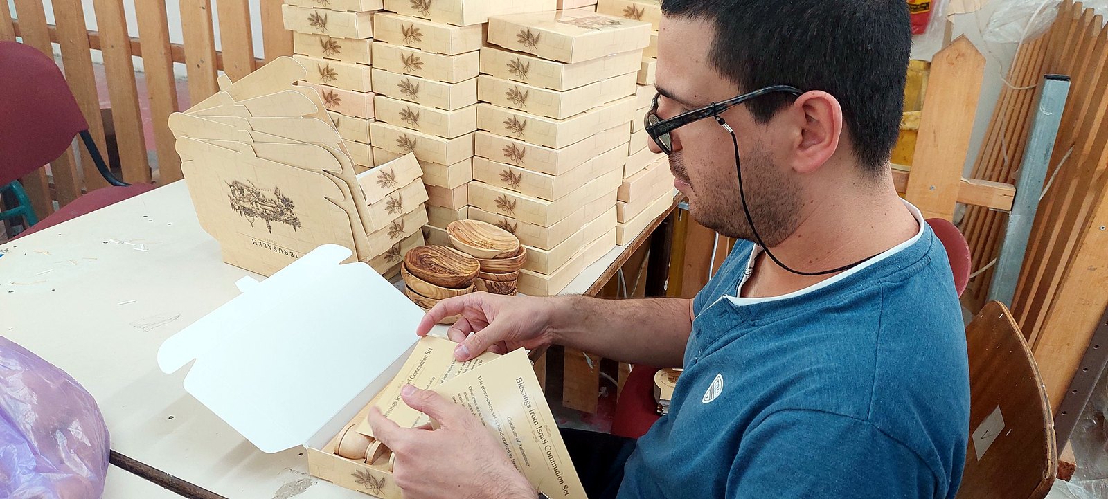 Communion set being packed with its certificate of authenticity