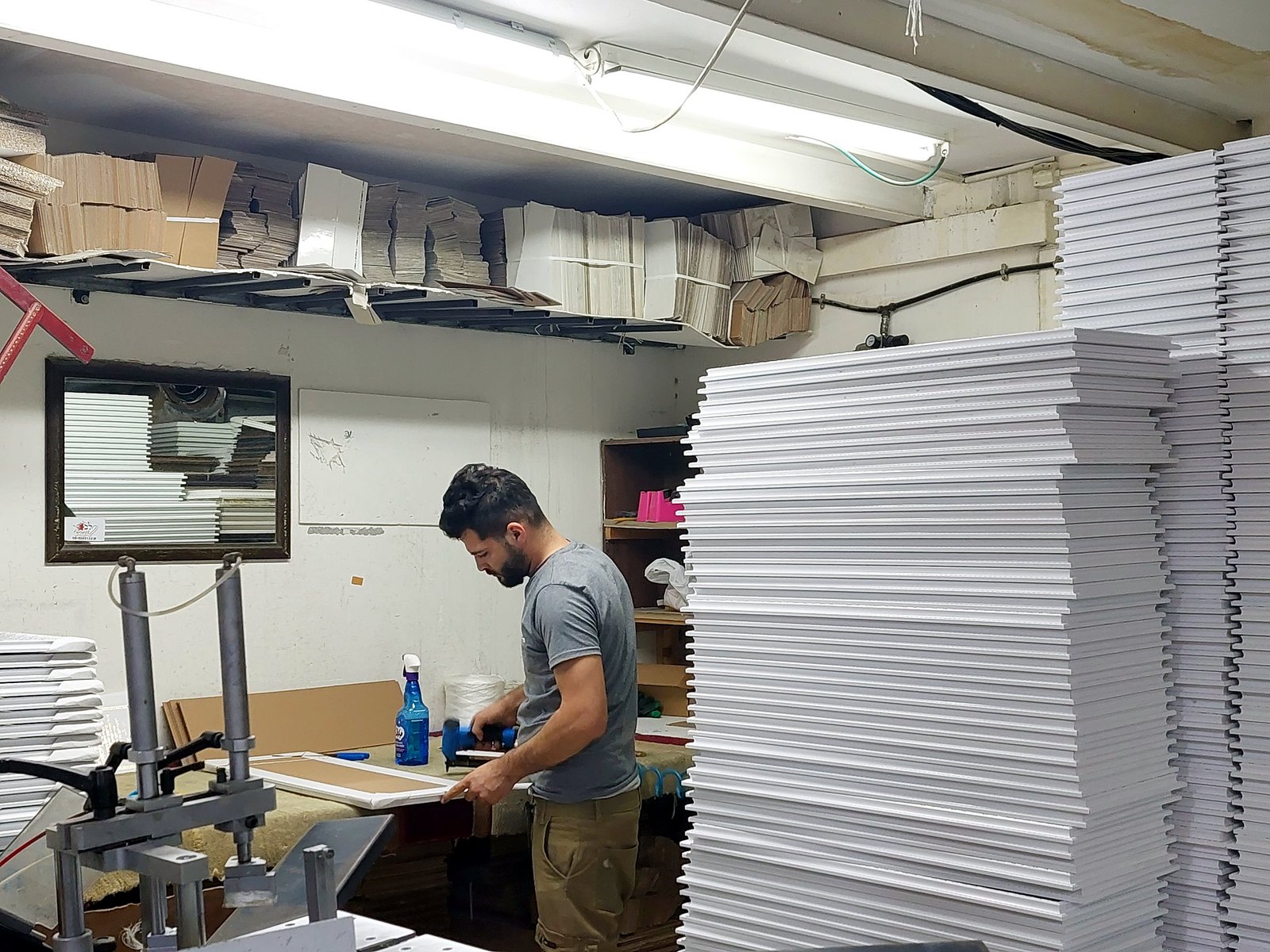 Framing a finished menorah relief in the workshop