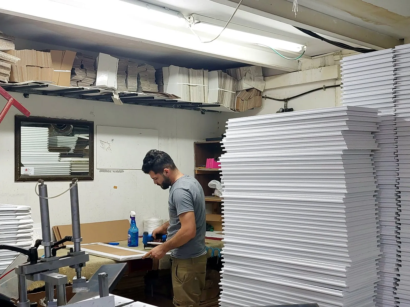 Artisan framing Scripture gifts in our Holy Land workshop