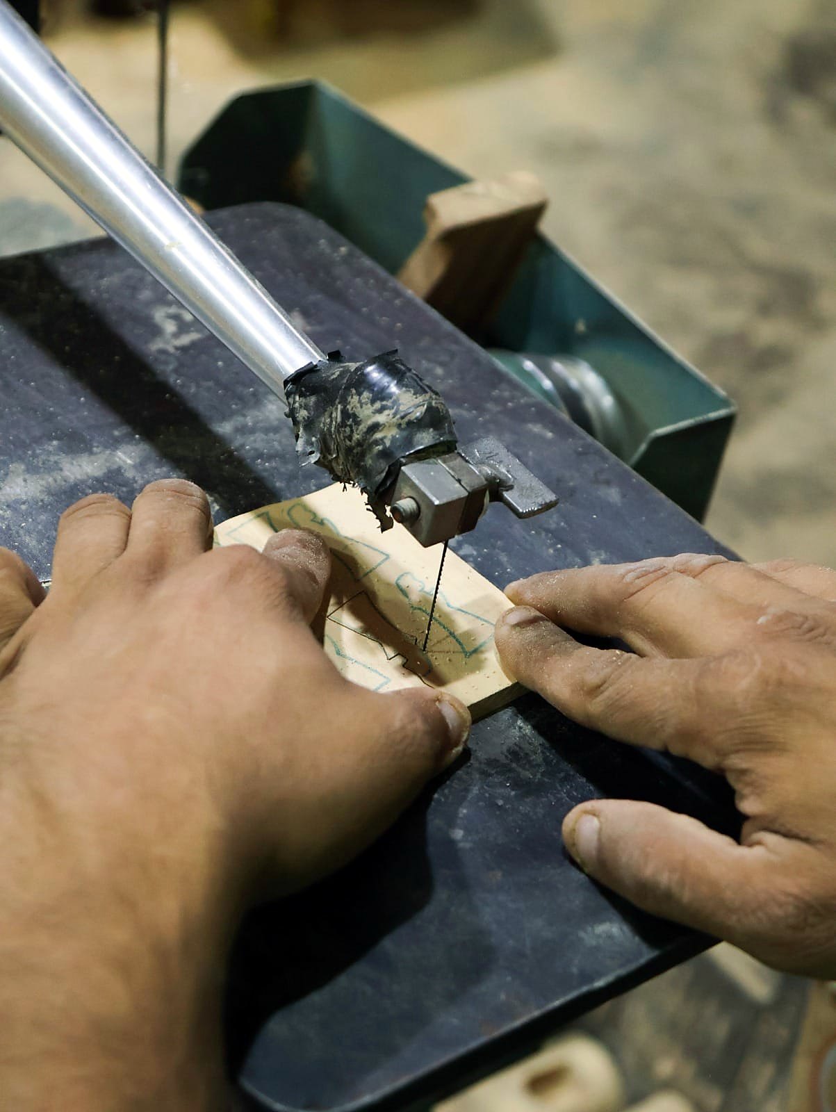 Cutting olive wood pieces for communion sets